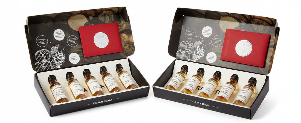 A collection of whisky bottles with labels, presented in a box with a red card and a graphic design on the inside. The bottles are displayed in a row, showcasing different labels and a small bottle stopper.