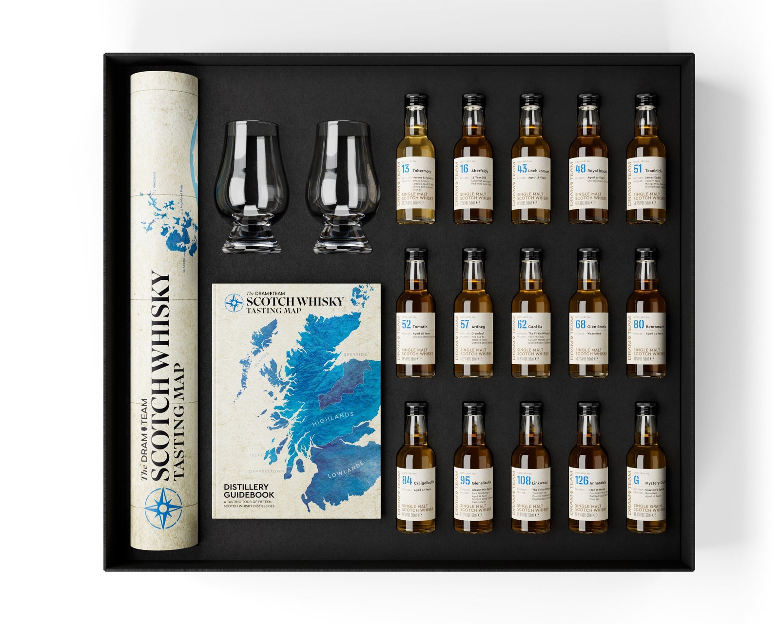 Whisky tasting set with bottles, glasses, and a map on a white background